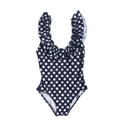 Mother and three children in matching black and white polka dot one-piece swimsuits with ruffled straps. - Image 9