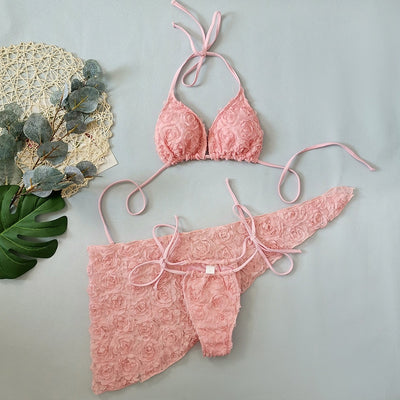 Red three-piece bikini set with a halter top, tie-side thong bottom, and sarong, all featuring a raised floral pattern. - Image 23