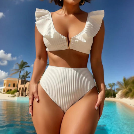 White ribbed bikini with ruffled shoulder straps and high-waisted bottoms on a model at a tropical beach.