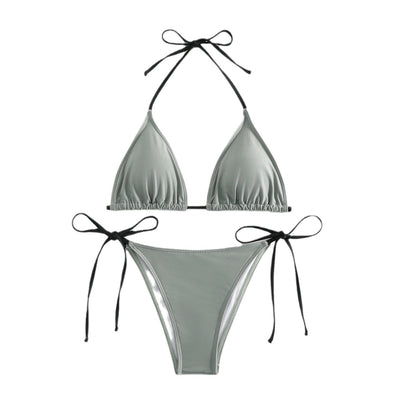 Neon yellow halter bikini with triangle top and tie-side bottoms, displayed on a light wood surface. - Image 2
