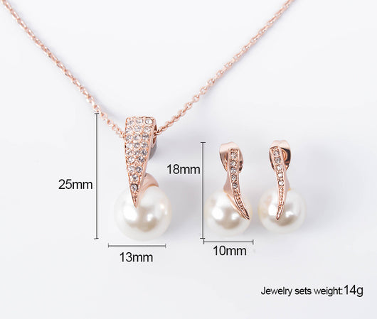 Rose gold-toned necklace and drop earrings set with white spherical pearls and clear rhinestone accents. - Image 6