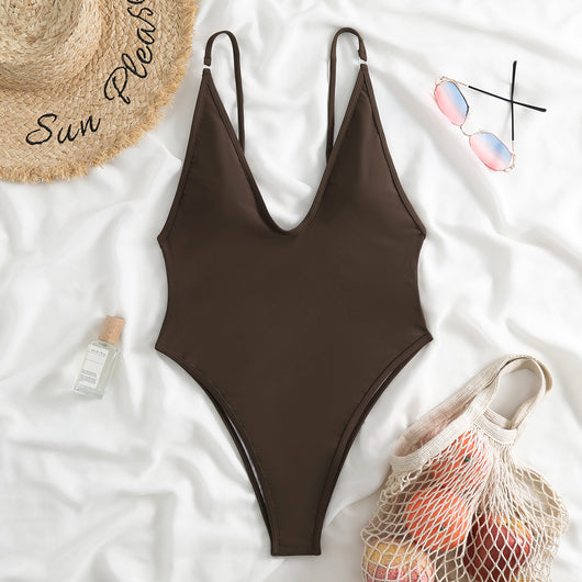 Dark brown one-piece swimsuit with a deep V-neckline and thin adjustable straps, styled with a straw hat and sunglasses. - Image 18