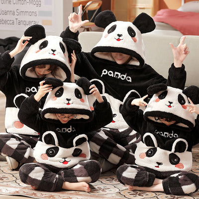 Family wearing matching black and white panda plush housewear suits with hoods and checkered pants, posing indoors. - Image 10