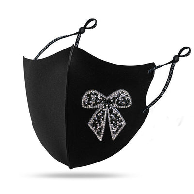 Black cloth face mask with a sparkling red and silver rhinestone bow design and adjustable ear loops. - Image 11
