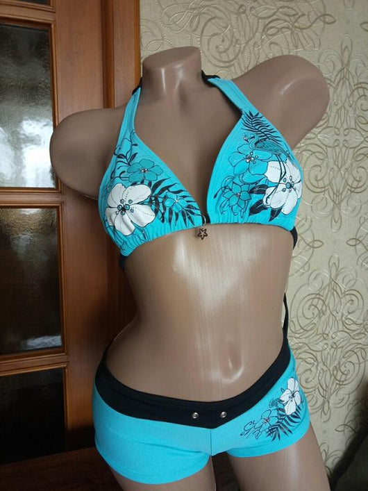 Black halter bikini suit with boy short bottoms, featuring pink and blue floral and flamingo patterns. - Image 10