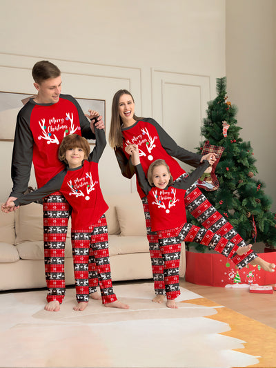 Family of four wearing matching red and black Christmas pajamas with a deer head and "Merry Christmas" print. - Image 5