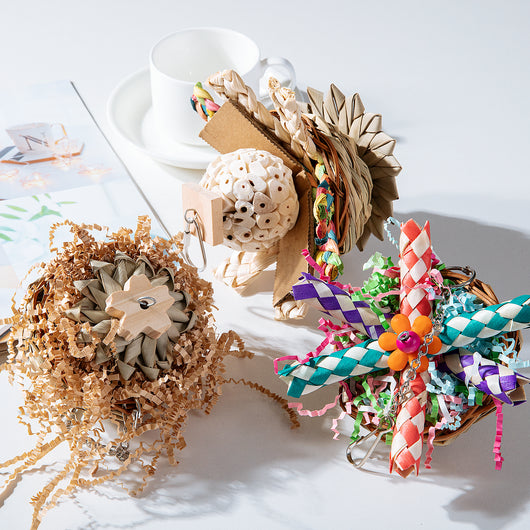 Colorful parrot bird toy with a woven basket base, braided chew sticks, crinkled paper, and a metal hanging chain. - Image 17