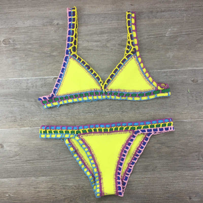 Pink crocheted bikini with silver knitted stitching, featuring a triangle top and matching bottom, laid flat. - Image 5
