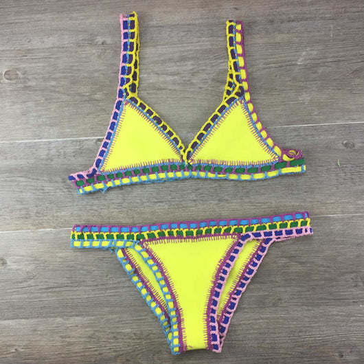 Pink crocheted bikini with silver knitted stitching, featuring a triangle top and matching bottom, laid flat. - Image 5