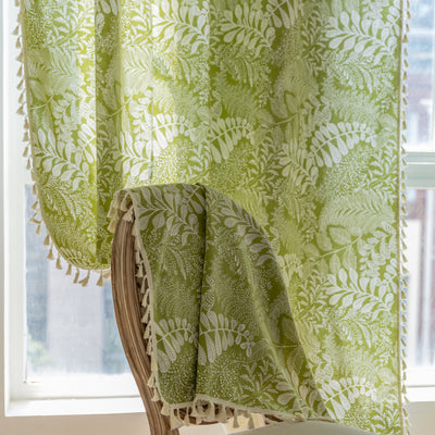 Green curtain with white leafy botanical pattern and cream tassels, hanging in a window with natural light. - Image 18