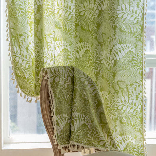 Green curtain with white leafy botanical pattern and cream tassels, hanging in a window with natural light. - Image 18