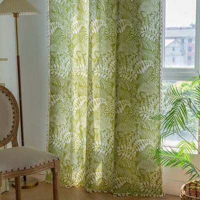 Green curtain with white leafy botanical pattern and cream tassels, hanging in a window with natural light. - Image 11