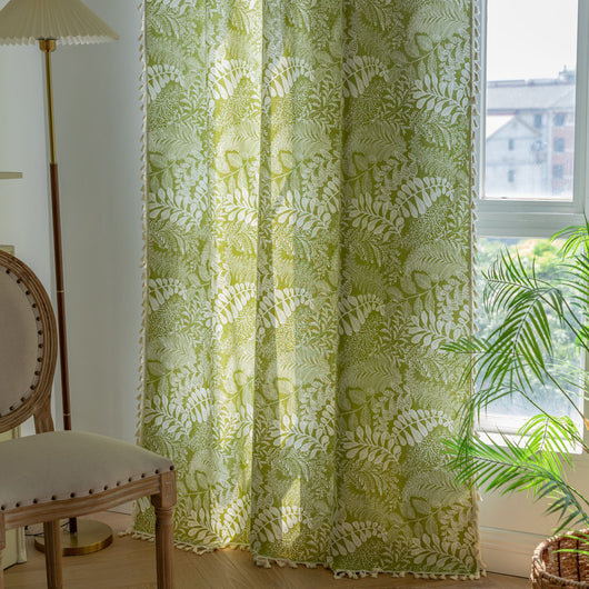 Green curtain with white leafy botanical pattern and cream tassels, hanging in a window with natural light. - Image 11