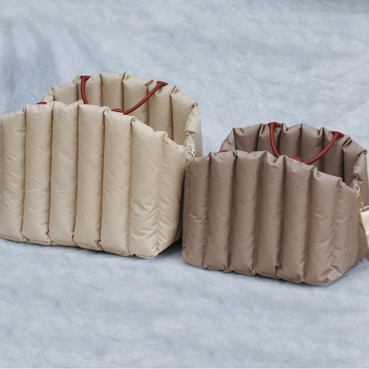 Light khaki quilted portable pet carrier with brown handles and a cream shoulder strap for car travel. - Image 3