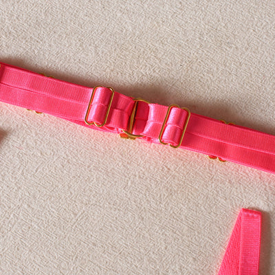 Black lace bra and thong set with hot pink harness straps, gold-tone rings, and a matching hot pink choker. - Image 10