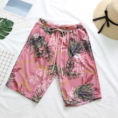 Pink tropical print three-piece women's swimwear set with ruffled bikini top, high-waisted bottoms, and matching sarong. - Image 9
