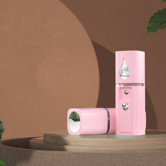White egg-shaped portable facial humidifier with a pink cartoon rabbit inside a clear dome, gold nozzle and button. - Image 22
