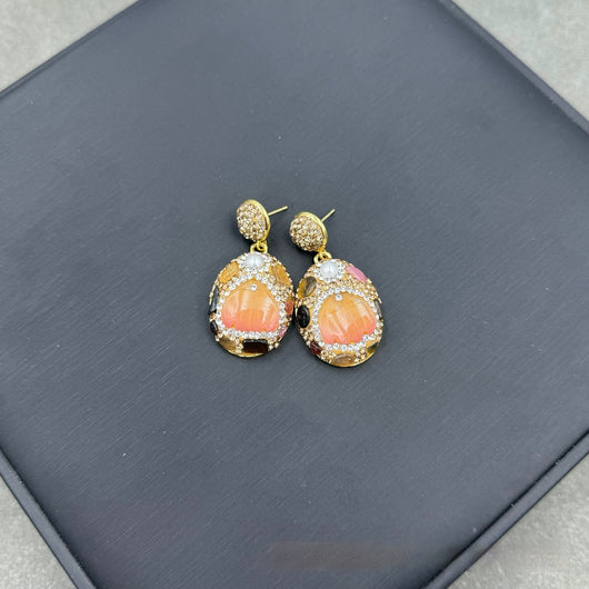 Gold-toned dangle earrings with oval drops, featuring a carved pink flower, clear rhinestones, and multi-colored tourmaline. - Image 7
