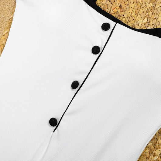 Woman in a white one-piece swimsuit with black trim and decorative buttons, sitting on a boat. - Image 16