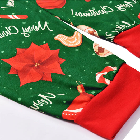 Green baby Christmas pajama romper with red trim, featuring candy canes, ornaments, gingerbread men, and poinsettias. - Image 16