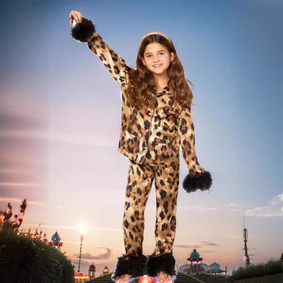 Young girl in a leopard print pajama set with black feather trim on the cuffs and ankles, wearing a pink glitter headband. - Image 3