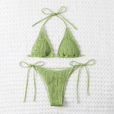 Women's lime green halter bikini with spaghetti straps and thong bottom, modeled outdoors against a blue sky. - Image 29