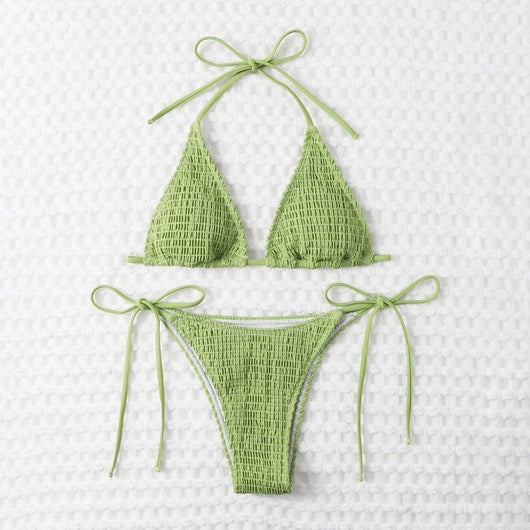 Women's lime green halter bikini with spaghetti straps and thong bottom, modeled outdoors against a blue sky. - Image 29