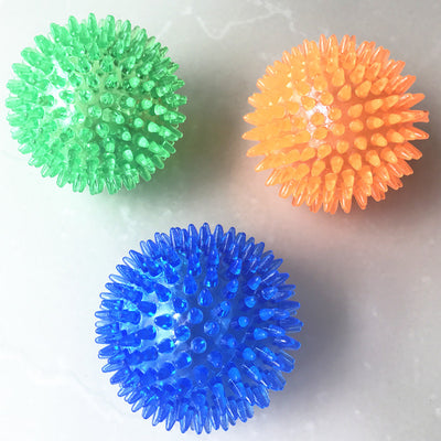 Red spiky TPR ball, a durable and bouncy toy for large dogs, designed for play and massage.