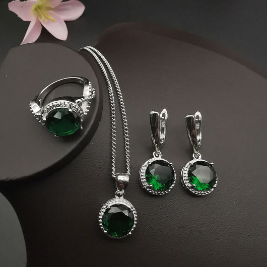 Four-piece silver-tone jewelry set with round green gemstones, including a necklace, bracelet, ring, and dangle earrings. - Image 15