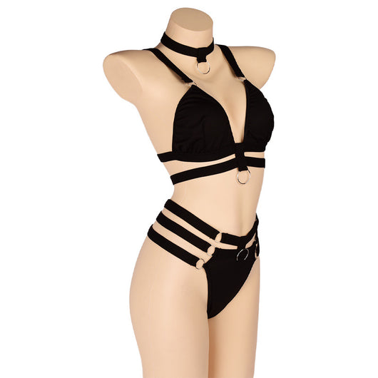 Woman wearing a royal blue strappy lingerie set with O-rings, including a bra, high-waisted bottoms, and a choker. - Image 21