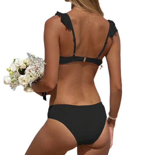 Green ruffled bikini with textured fabric and triangle top, modeled on a sunny beach. - Image 5