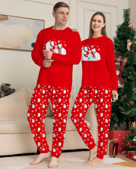 Family of four wearing matching red Christmas pajamas with polar bear and snowflake print, standing by a Christmas tree. - Image 5
