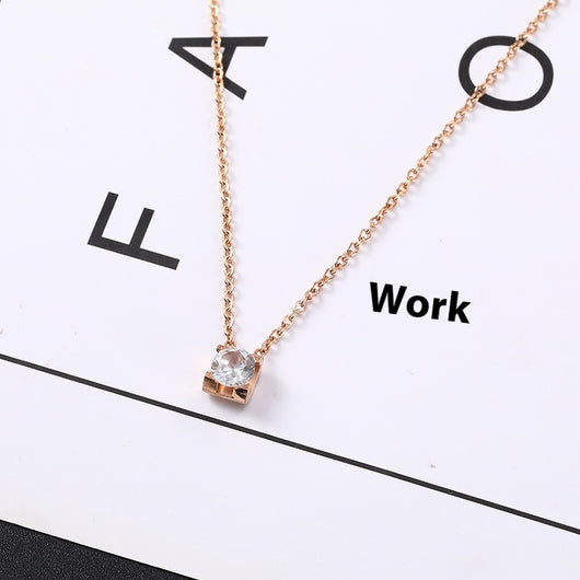 Delicate silver-colored chain necklace with a single square-cut clear stone pendant in a four-prong setting on a woman's neck. - Image 17