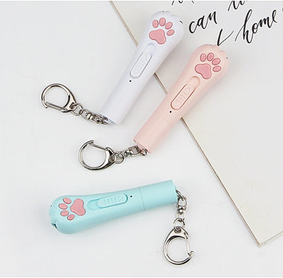 Light purple paw-shaped cat laser pointer toy with USB charging, featuring multiple red laser patterns, soft white light, and UV light. - Image 27