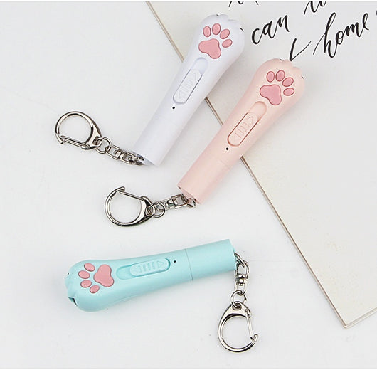 Light purple paw-shaped cat laser pointer toy with USB charging, featuring multiple red laser patterns, soft white light, and UV light. - Image 27