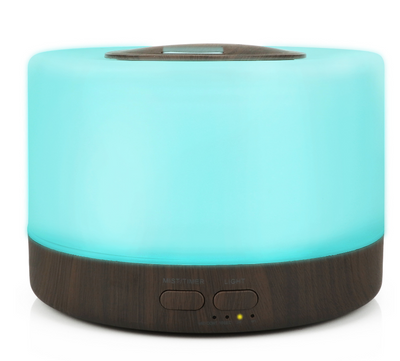 A cylindrical aromatherapy diffuser with a dark wood grain base and a translucent top glowing aqua blue, featuring control buttons. - Image 11