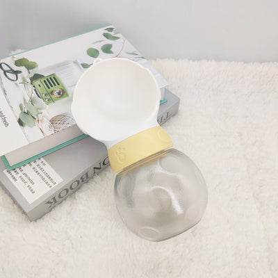 Portable pet water bottle with white drinking bowl, translucent grey reservoir, and yellow paw print band. - Image 3