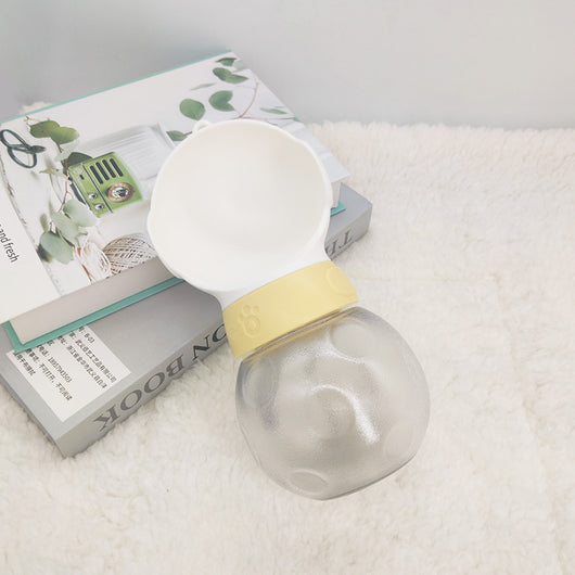 Portable pet water bottle with white drinking bowl, translucent grey reservoir, and yellow paw print band. - Image 3