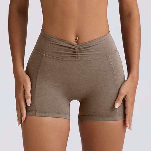 Light pink halter neck sports bra and high-waisted leggings workout set on a model. - Image 28