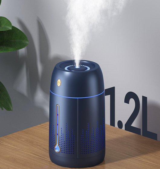 White cylindrical household humidifier with a visible water level indicator, next to its brown cardboard packaging. - Image 14