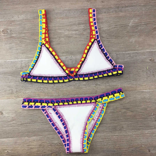 Pink crocheted bikini with silver knitted stitching, featuring a triangle top and matching bottom, laid flat. - Image 4
