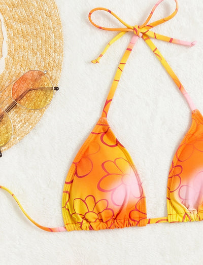 Yellow and orange floral string bikini swimsuit for women, featuring a triangle top and high-cut bottoms by a pool. - Image 8