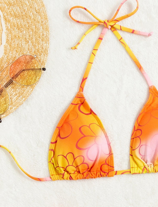 Yellow and orange floral string bikini swimsuit for women, featuring a triangle top and high-cut bottoms by a pool. - Image 8