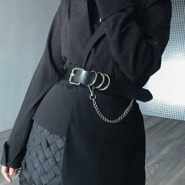 Black waist belt with single shoulder strap, silver buckle, D-rings, and decorative chain.