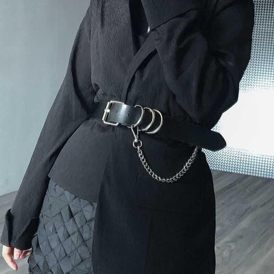 Black waist belt with single shoulder strap, silver buckle, D-rings, and decorative chain.