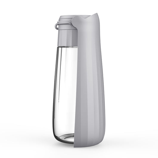 Yellow 450ml portable pet water bottle with a folding drinking trough and white wrist strap, on grass. - Image 5