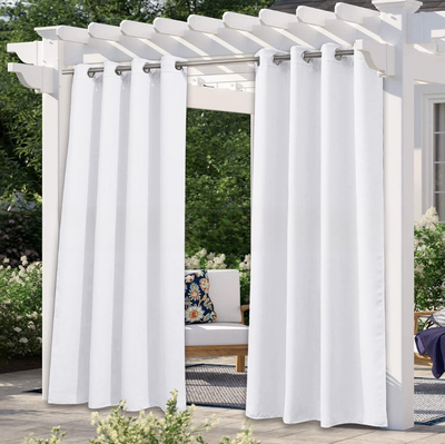Solid gray outdoor curtain panels with grommet tops hanging from a white pergola on a sunny patio. - Image 12
