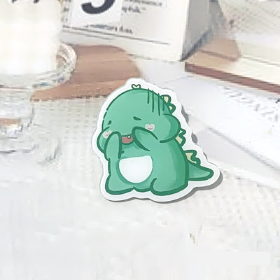 Cute green cartoon dinosaur acrylic badge brooch with a shy expression and small spikes on its back. - Image 9
