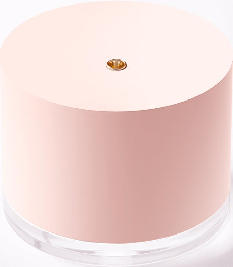 Pink cylindrical mini wireless humidifier with a clear base and a small gold mist outlet on top. - Image 6