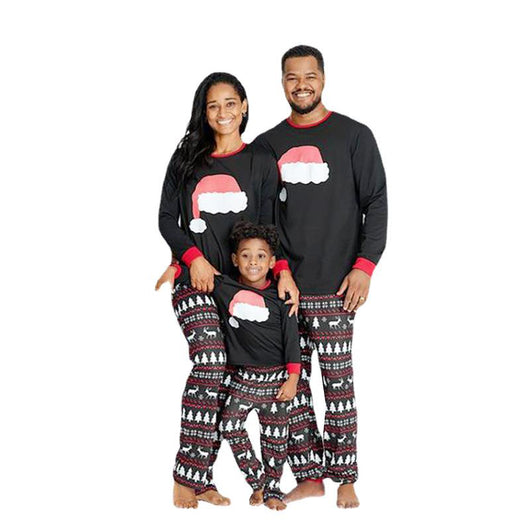 Family of three wearing matching black Christmas pajamas with Santa hat tops and reindeer fair isle pants. - Image 10